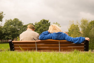 senior couple sitting on a bench