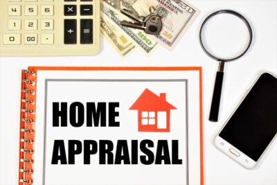 home appraisal. the inscription in the document form on the planning folder against the background of a calculator, cash, a key and a magnifying glass for research. services of realtor offices.